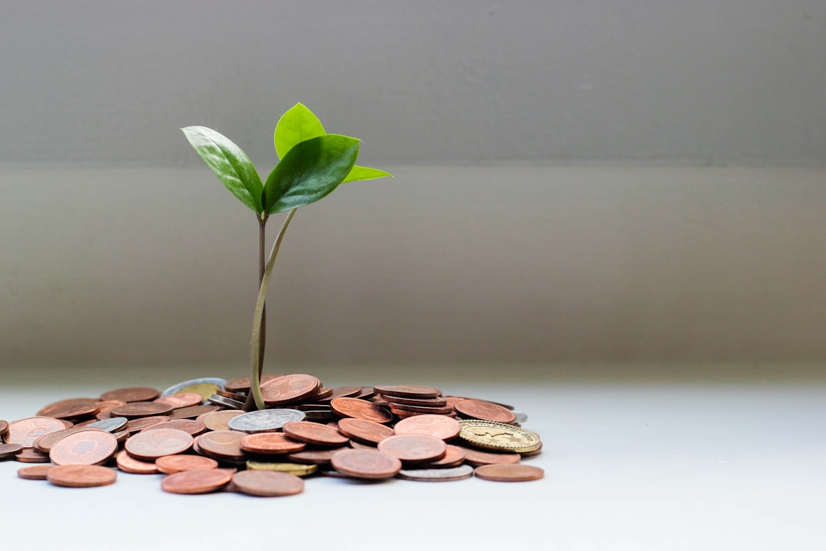 Hands placing coins into labeled jars representing separate savings goals